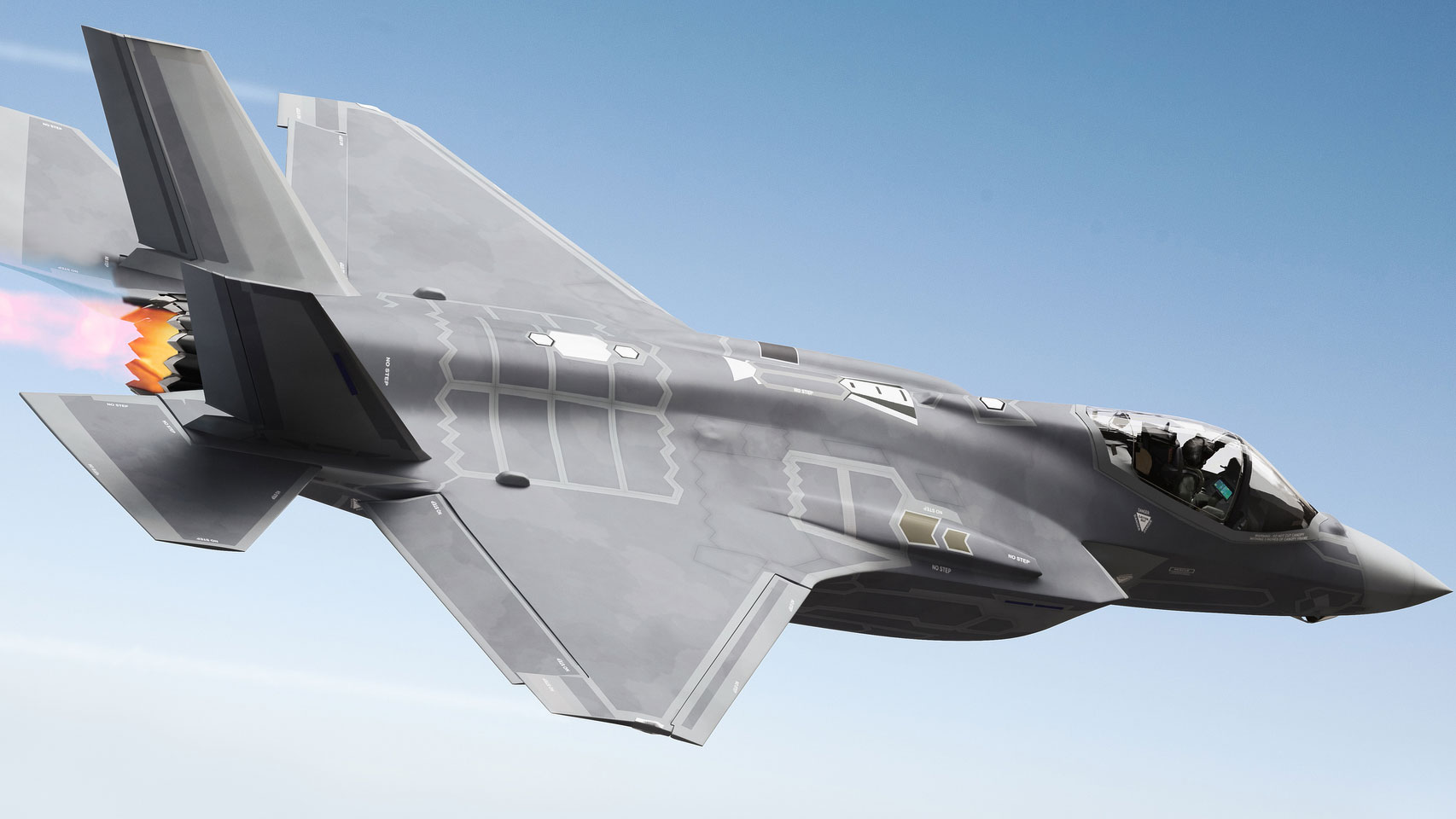 A military jet flying in a clear blue sky